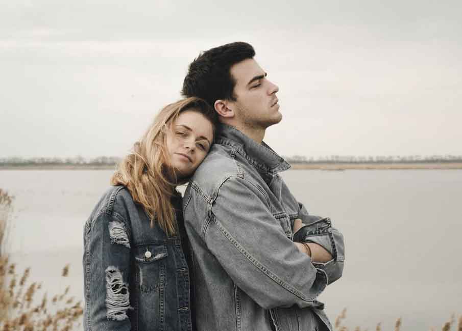 A photo of a women leaning on a man’s shoulder